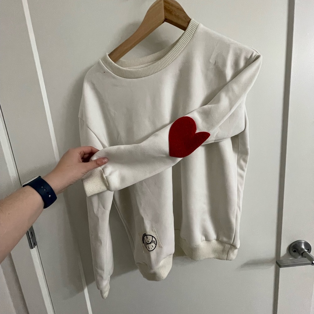 white sweatshirt, red hearts on elbows